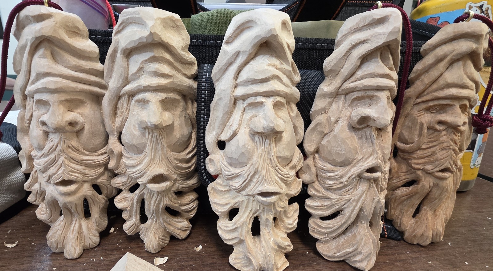 Hand-carved wooden Santa Claus sculptures with detailed beards and hats